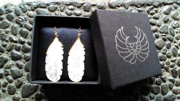 Shell carved earrings of an owl feather